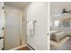 Well-lit bathroom featuring a shower with glass door and modern fixtures, adjacent to the bedroom at 2120 Gross Dam Rd, Golden, CO 80403