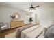 Comfortable bedroom featuring a ceiling fan, a large window, and wooden dresser at 2120 Gross Dam Rd, Golden, CO 80403