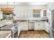 Well-lit kitchen with stainless appliances, granite counters, and hardwood floors at 2120 Gross Dam Rd, Golden, CO 80403