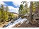 Scenic view of trees and large boulders on property overlooking landscape view in background at 2120 Gross Dam Rd, Golden, CO 80403