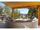 An outdoor deck with a grill, comfortable seating, and stunning mountain views at 2120 Gross Dam Rd, Golden, CO 80403