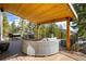 A covered outdoor deck with ample seating, a grill, and scenic mountain views at 2120 Gross Dam Rd, Golden, CO 80403