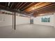 Unfinished basement featuring exposed ceiling beams and natural light from a window at 34586 Morgan Trl, Elizabeth, CO 80107