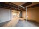 Unfinished basement featuring a laundry area with multiple washing machines and utility connections at 34586 Morgan Trl, Elizabeth, CO 80107