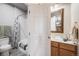 Bright bathroom featuring a shower and tub combination, toilet, and wooden vanity with sink at 34586 Morgan Trl, Elizabeth, CO 80107