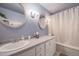 Well-lit bathroom with dual mirrors, and a bathtub/shower combination at 34586 Morgan Trl, Elizabeth, CO 80107