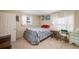 Bedroom with a bed, floral quilt, bedside table, and a window at 34586 Morgan Trl, Elizabeth, CO 80107