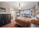 Spacious bedroom with wood floors, large windows, dresser and vanity furniture at 34586 Morgan Trl, Elizabeth, CO 80107