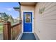 Close-up of a vibrant blue front door with decorative glass and a covered porch for added curb appeal at 34586 Morgan Trl, Elizabeth, CO 80107