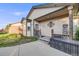 Inviting front entrance with a blue door, covered porch, well-kept walkway, and charming exterior details at 34586 Morgan Trl, Elizabeth, CO 80107