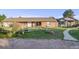 Ranch-style brick home with mature landscaping and a partial wooden fence at 34586 Morgan Trl, Elizabeth, CO 80107