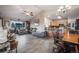 Comfortable living room with vaulted ceilings, tile flooring, a ceiling fan, and seamless connection to an open kitchen at 34586 Morgan Trl, Elizabeth, CO 80107