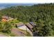 Aerial view of a home with solar panels surrounded by lush greenery and trees, with a scenic mountain backdrop at 812 Aspen Rd, Golden, CO 80401