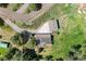 A lovely home is shown from an aerial view, featuring a solar panel roof and a scenic, lush surrounding landscape at 812 Aspen Rd, Golden, CO 80401