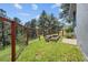 Fenced yard with a garden bed featuring mature trees and lush greenery for a private outdoor space at 812 Aspen Rd, Golden, CO 80401