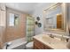 Neutral-toned bathroom features a tub, shower, and vanity with bright, natural lighting at 812 Aspen Rd, Golden, CO 80401