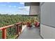 Spacious covered deck with comfortable seating offers serene views of the surrounding forest at 812 Aspen Rd, Golden, CO 80401