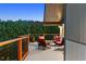 Expansive deck area with comfortable seating, offering panoramic views of the lush forest and a perfect spot for relaxation at 812 Aspen Rd, Golden, CO 80401