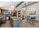 Open-concept kitchen with granite countertops, island, modern lighting, and dining area at 812 Aspen Rd, Golden, CO 80401