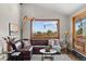 Bright living room features comfortable sofa and big windows offering views of the natural landscape at 812 Aspen Rd, Golden, CO 80401