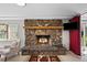 Living room featuring stone fireplace, natural light, and cozy seating arrangement at 812 Aspen Rd, Golden, CO 80401