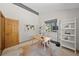 Well-lit office space with light walls, wood door, shelving, and a neutral area rug at 812 Aspen Rd, Golden, CO 80401