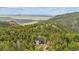 Aerial view of the modern home nestled among the trees, providing privacy and beautiful natural scenery at 13910 Blue Jay Ln, Larkspur, CO 80118