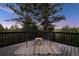 Relax on this balcony with stylish seating, rug and table as you enjoy the trees and sunset at 13910 Blue Jay Ln, Larkspur, CO 80118