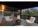 This covered deck is ideal for relaxation with ample seating, a fire pit and scenic wooded views at 13910 Blue Jay Ln, Larkspur, CO 80118