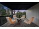 Covered balcony with outdoor seating and a fire pit, perfect for relaxing with wooded views at 13910 Blue Jay Ln, Larkspur, CO 80118