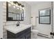Modern bathroom featuring subway tile, black fixtures, a new vanity and a shower with glass door at 13910 Blue Jay Ln, Larkspur, CO 80118