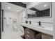 Modern bathroom features a double sink vanity, sleek black fixtures, and stylish tile accents at 13910 Blue Jay Ln, Larkspur, CO 80118
