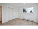 Bedroom with a window and closet featuring plank flooring and modern decor at 13910 Blue Jay Ln, Larkspur, CO 80118