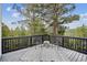 Outdoor deck with seating area and scenic views of the surrounding forest and a geometric patterned rug at 13910 Blue Jay Ln, Larkspur, CO 80118