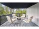 Outdoor deck with a fire pit and comfortable seating area with scenic views of the surrounding forest at 13910 Blue Jay Ln, Larkspur, CO 80118