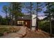 Attractive multi-level home featuring an attached garage with a rock lined pathway at 13910 Blue Jay Ln, Larkspur, CO 80118