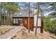 Charming multi-level home featuring an attached garage and a rock lined pathway at 13910 Blue Jay Ln, Larkspur, CO 80118