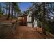 A beautiful home with an attached garage surrounded by tall trees, offering privacy and seclusion at 13910 Blue Jay Ln, Larkspur, CO 80118