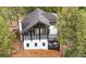 Striking two-story modern home with floor to ceiling windows and an inviting deck surrounded by lush green trees at 13910 Blue Jay Ln, Larkspur, CO 80118