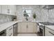 This modern kitchen features pristine countertops, stainless steel appliances, and stylish backsplash at 13910 Blue Jay Ln, Larkspur, CO 80118