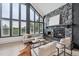 Inviting living room featuring a stone fireplace and large windows at 13910 Blue Jay Ln, Larkspur, CO 80118