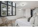 Airy main bedroom with large windows and closet offering lots of natural light at 13910 Blue Jay Ln, Larkspur, CO 80118