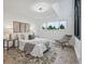 Bright main bedroom with a large window, a cozy seating area, and modern decor at 13910 Blue Jay Ln, Larkspur, CO 80118