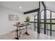 Bright office area with large windows, a spacious desk, and scenic views at 13910 Blue Jay Ln, Larkspur, CO 80118