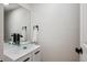 Stylish powder room with a vessel sink, modern faucet, and sleek black hardware at 13910 Blue Jay Ln, Larkspur, CO 80118