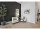 Cozy sitting room with plush chairs, a dark accent wall, and a view of the outdoors at 13910 Blue Jay Ln, Larkspur, CO 80118