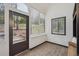 Bright sun room featuring plank flooring, natural light and views of the landscape at 13910 Blue Jay Ln, Larkspur, CO 80118