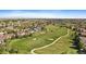 An aerial view shows the property situated near a golf course and a well-maintained, Gathering-friendly community at 22023 E Heritage Pkwy, Aurora, CO 80016