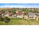Aerial view of home with a brown roof, professional landscaping, and views of the surrounding community at 22023 E Heritage Pkwy, Aurora, CO 80016
