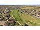 This aerial view captures the house within the larger community that features a golf course and ample green space at 22023 E Heritage Pkwy, Aurora, CO 80016